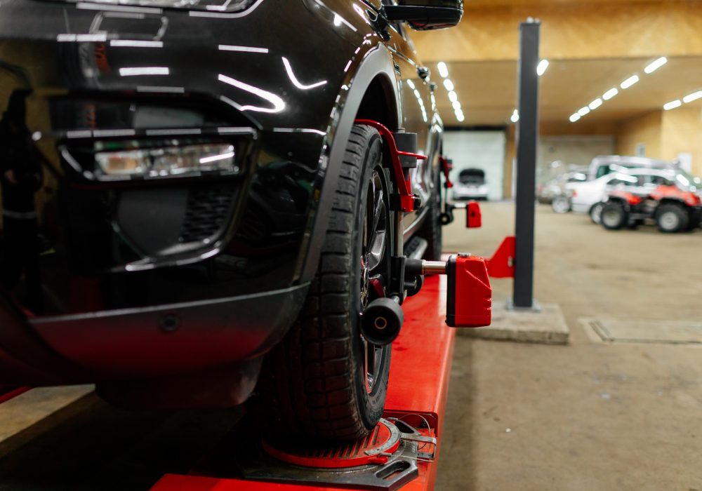 Car with installed wheel alignment sensors at a repair station
